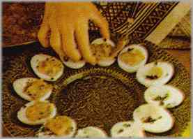 Poner los huevos en una fuente de servir redonda, rellenarlos con parte del relleno y poner el resto en una salsera en el centro de la fuente.