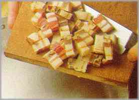 Dorar en una sartén con aceite hirviendo la panceta ahumada cortada en cuadraditos.