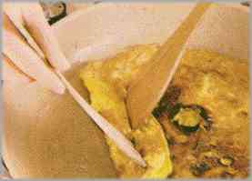 Calentar unas gotas de aceite y hacer una tortilla con los huevos batidos.
