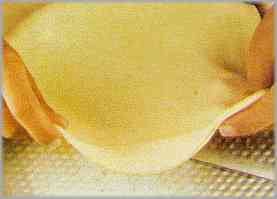 Extender una capa fina para cubrir el molde, untado de mantequilla.